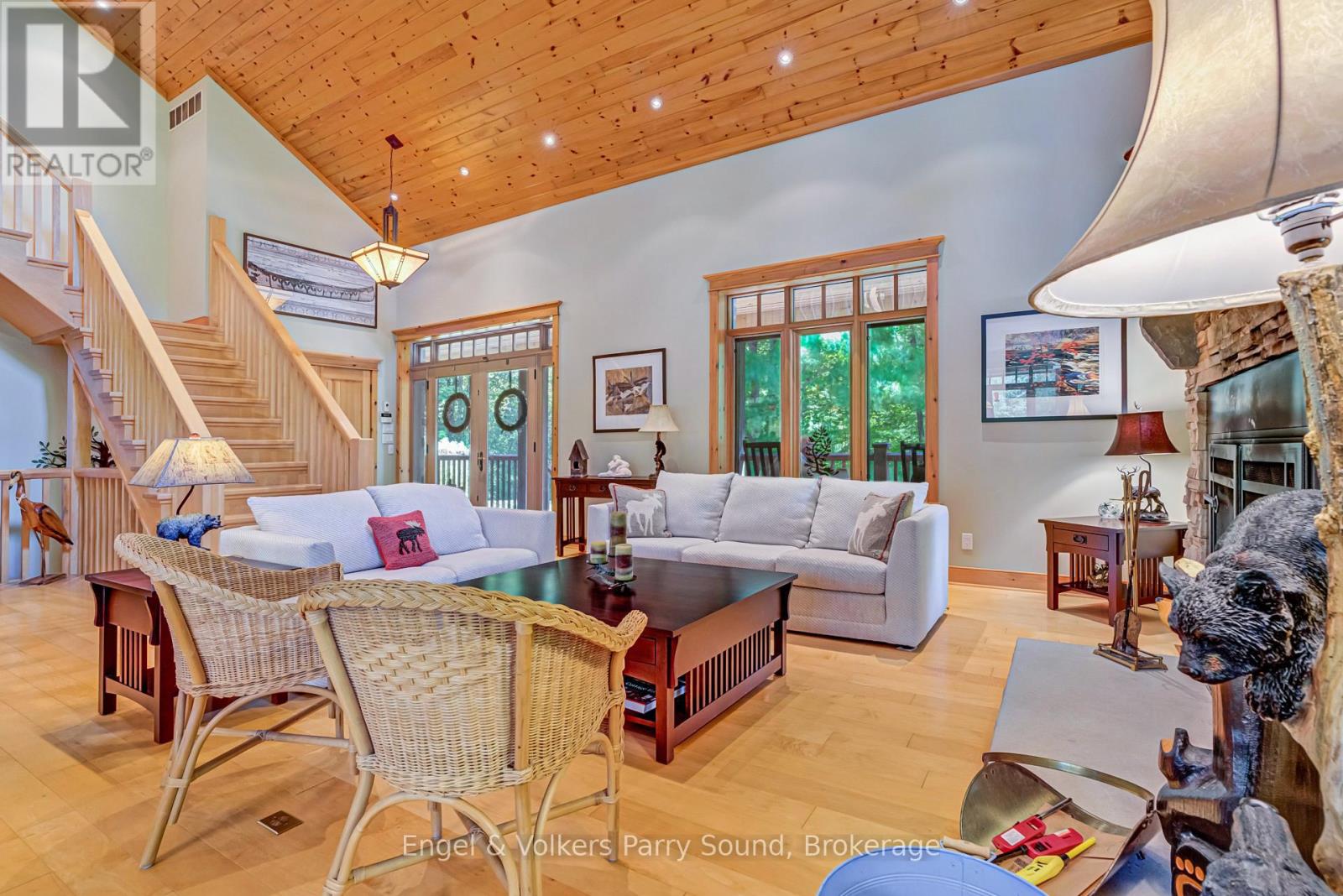Open-concept living beneath a vaulted wood ceiling
